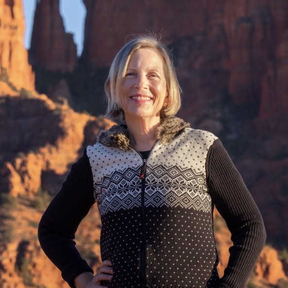 Carla Williams standing before Sedona's red rock cliffs