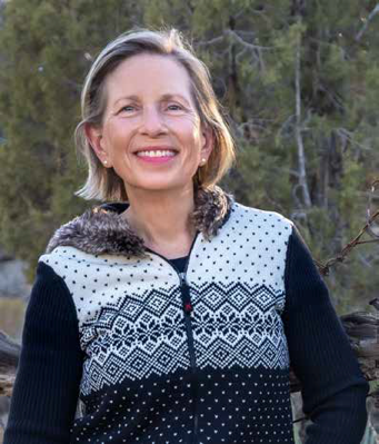 Carla Williams, KSB President, smiling outdoors in a patterned sweater